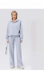 Detail of light blue half-zip sweatshirt with fine ribbed texture for sports
