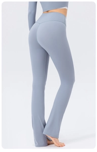 Rear view of light blue high-waist flared yoga pants showing V-shape lifting seam detail