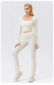 Detail of square neck yoga top with thumbhole cuffs and split-hem flared leggings