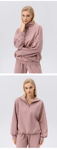 Detail of dusty pink half-zip sports sweatshirt with ribbed cuffs and drop shoulder