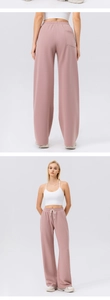 Detail of high waisted pink wide leg joggers with drawstring waist and back pocket