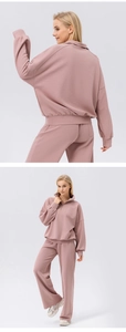 Detail of pink half-zip sweatshirt with drop shoulder and matching wide leg pants