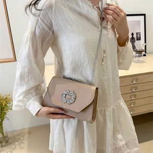 Elegant beige crossbody bag with rhinestone buckle and silver chain strap for women