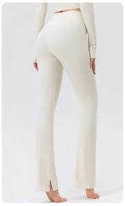 Detailed back view of high-waisted yoga pants with flared split hem in creamy white