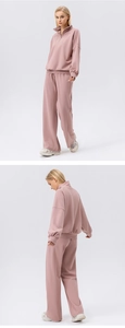 Detail of a dusty pink sports sweatshirt with half-zip collar and ribbed cuffs
