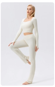 Detail view of high-waisted yoga pants with split flared hem and thumbhole sleeve top