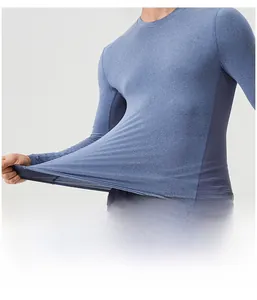 Close-up of men's blue athletic long sleeve shirt showing high elastic performance fabric