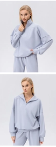 Detail view of the waffle knit texture and half-zip collar on a light blue sports set