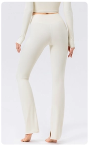 Detail view of high waisted flared yoga pants featuring back slit and tummy control design