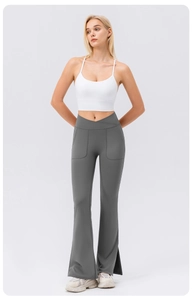 Detail view of the high-waisted crossover waistband and side pockets on grey flared yoga pants