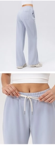 Detail view of high-waist yoga pants with elastic drawstring and back pocket