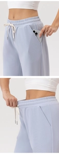 Detail of high-waist elastic waistband with drawstring and side pocket for phone