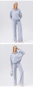 Detail of light blue half-zip sweatshirt and wide-leg jogger set with a high-waist fit