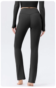 Rear view of black high-waisted flared yoga pants showing V-shape lifting seam detail
