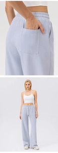 Detail view of back square pocket on wide-leg high-waisted sports trousers for women