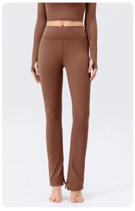 Detail of high waisted yoga pants with thumbhole cuffs and split flared hem in brown