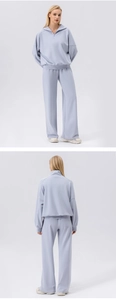 Detail of light blue wide-leg sports pants and quarter-zip sweatshirt lounge set