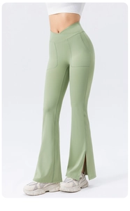 Macro detail of high-waist yoga flare pants with crossover design and side slit hem