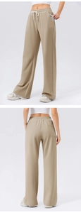 Detail of high-waist wide-leg sweatpants featuring side pockets and adjustable drawstring