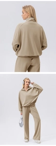 Close-up of beige half-zip sweatshirt with high collar and wide-leg knit lounge pants