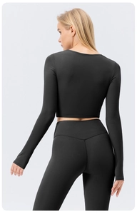 Rear view of black long sleeve yoga set with high waist V-cut leggings and crop top