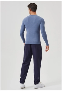 Rear view of men's blue quick-dry long sleeve compression shirt and gym pants set