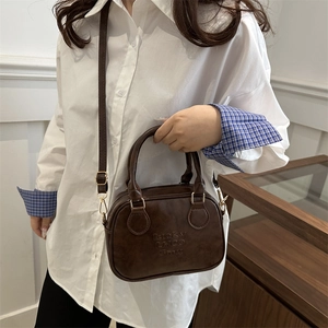 Vintage brown bowling bag with embossed letters for casual hand or crossbody carry