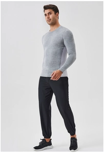 Full body view of men's gray long sleeve quick-dry sports t-shirt and black pants