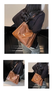 Detail of a brown leather shoulder bag featuring a gold turn-lock pocket and chain strap