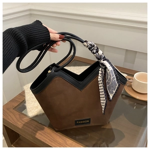 Detail of coffee brown tote bag featuring a V-shaped opening and printed silk scarf handle