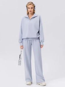 Women's light blue lounge set with half-zip sweatshirt and wide-leg sports pants