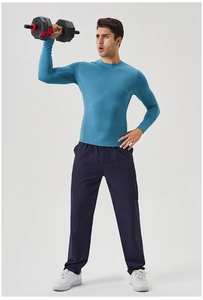 Detail of teal long sleeve compression top and navy pants with drawstring waist