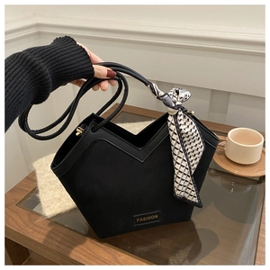 Detailed view of black V-cut tote bag with silk scarf handle and FASHION tag