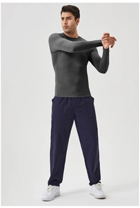 Detail showing high-elasticity breathable mesh panels and side stitching of men fitness top