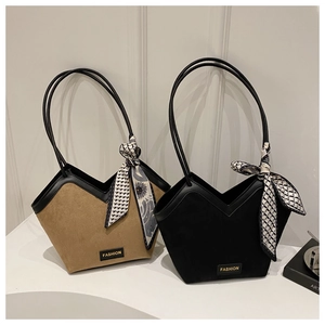 Detail of minimalist tote bags featuring suede texture, silk scarf and fashion metal tag