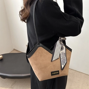Brown suede tote bag with V-shaped opening and decorative floral scarf on handle