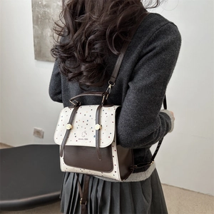 Chic 2025 retro polka dot backpack with brown leather trim and twin shoulder straps