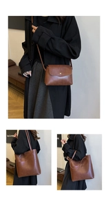Detail of vintage brown leather tote bag and crossbody pouch with gold heart buckle accent