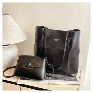 Black leather tote and crossbody bag set for women shown in a cozy home lifestyle setting