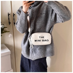 White textured leather crossbody bag with The Mini Bag print and wide patterned strap