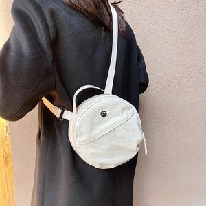 Minimalist white round nylon crossbody bag for women with wide adjustable shoulder strap