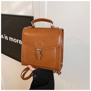 Detailed view of the brown vintage PU leather handbag featuring a silver buckle and handle
