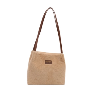 Plush faux fur tote bag in light camel with slim shoulder straps and leather patch