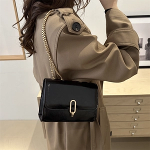 French style black glossy leather crossbody bag with gold chain and oval buckle