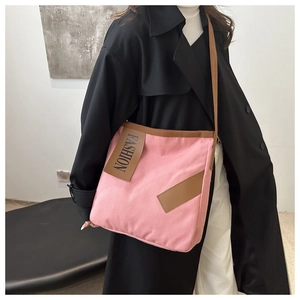 Pink canvas crossbody tote with contrast brown straps and fashion print detail