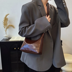 Dark brown minimalist faux leather half-moon shoulder bag with adjustable strap