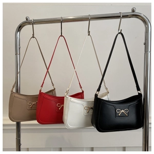 Detailed display of underarm bags in four colors with gold metal bow decorations