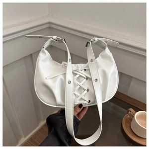 Close-up of white PU handbag featuring corset-style lace-up detailing and silver hardware