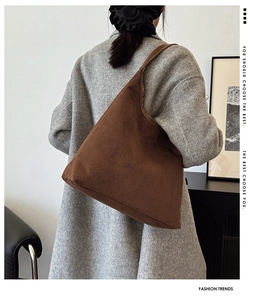 Brown corduroy tote bag detail showing large capacity and soft texture on wool coat