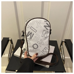 Detailed view of cream PU leather crossbody bag featuring leopard print letter patterns
